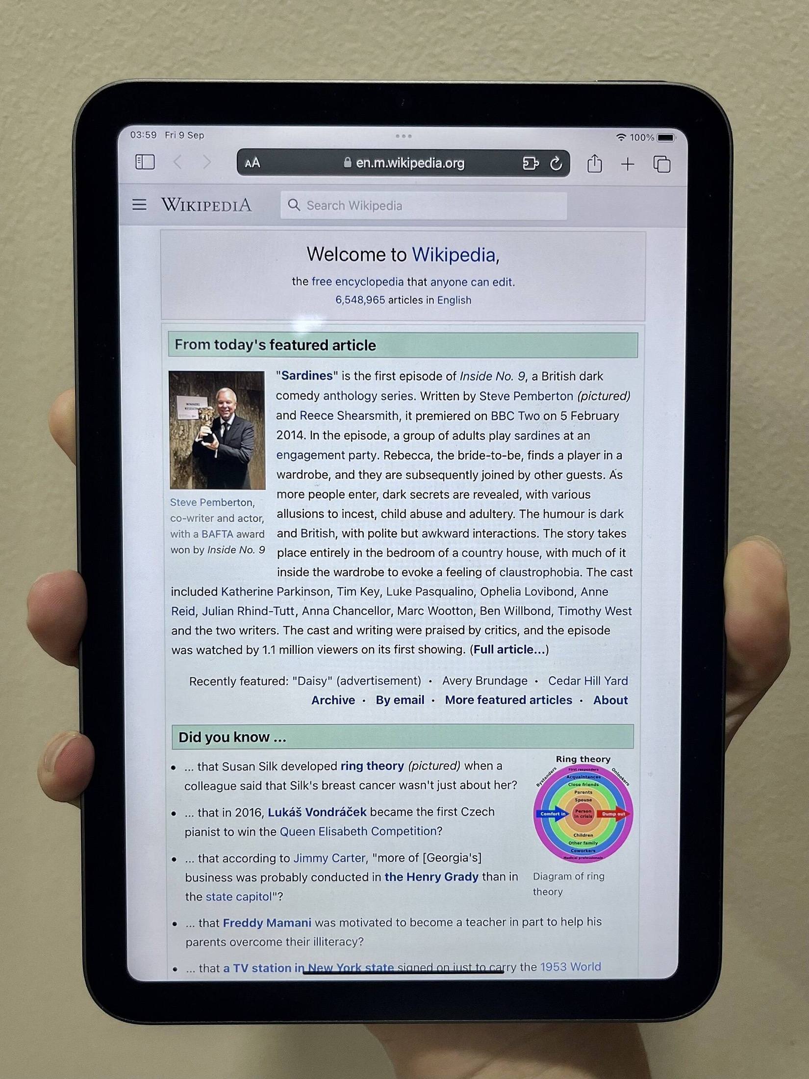 iPad mini held in one hand